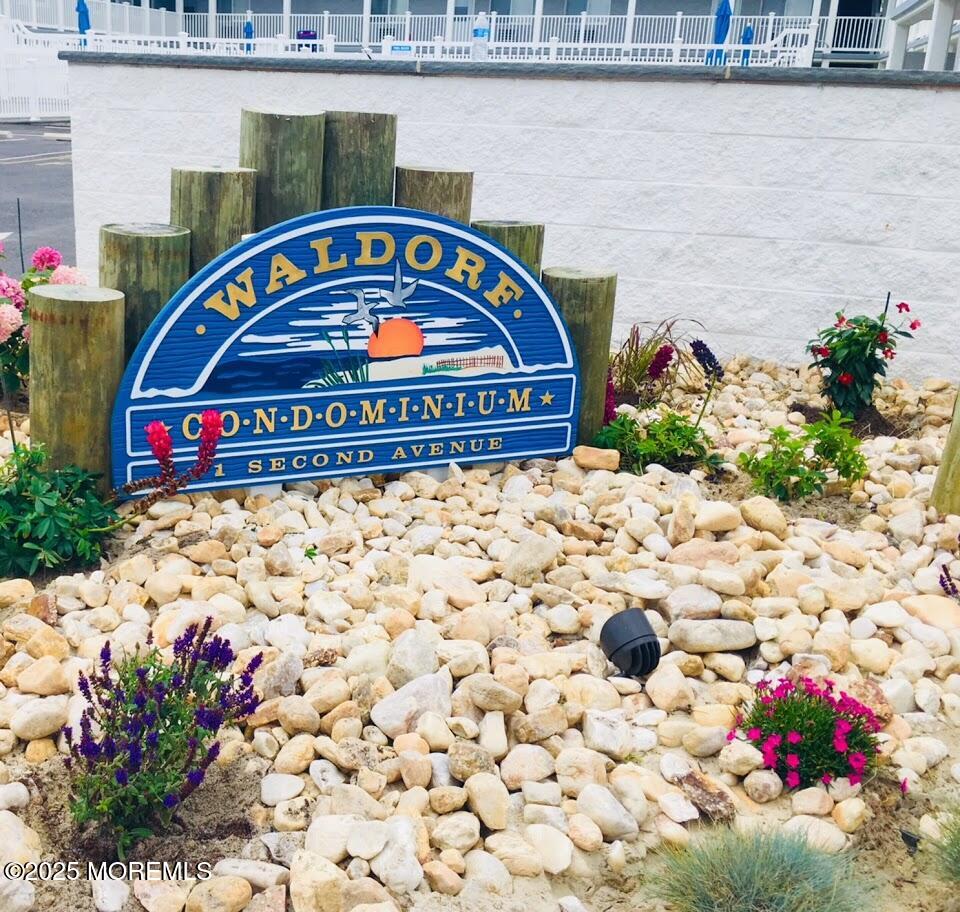 1 2nd Avenue, Unit 34 Seaside Heights, NJ 08751 - Photo 4 of 19 a sign that is sitting in front of flowers