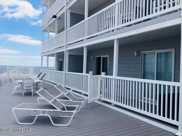 a view of a house with wooden deck