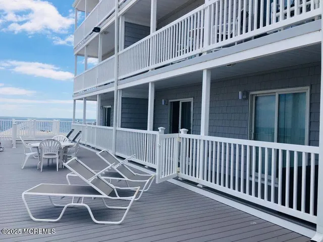 a view of a house with wooden deck