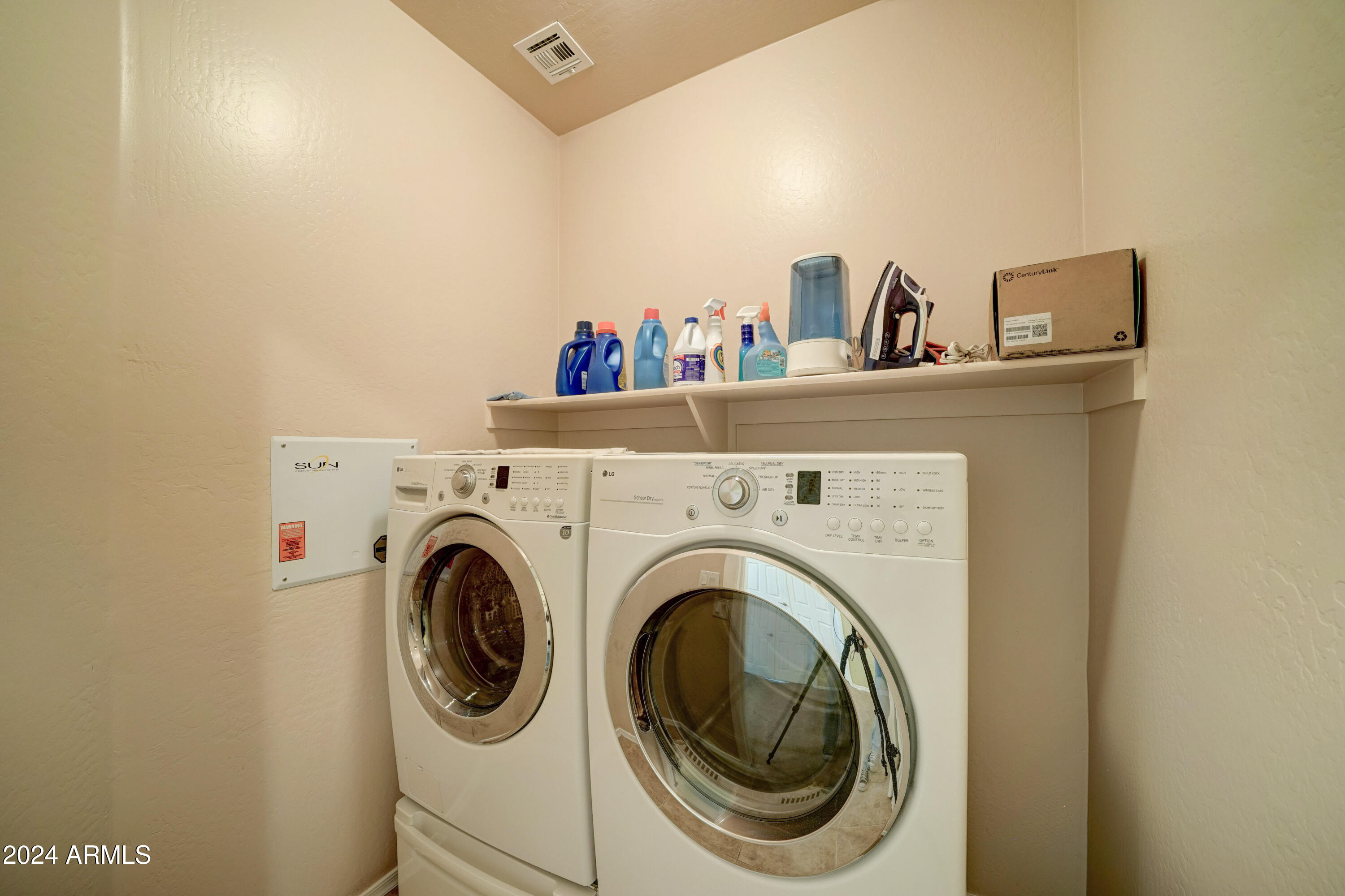 2101 South Meridian Road, Unit 131 Apache Junction, AZ 85120 - Photo 14 of 59 a view of washer and dryer with kitchen in the background