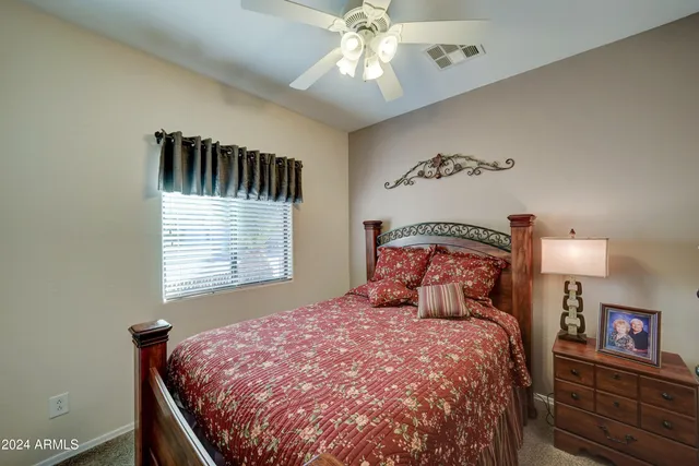 a bedroom with a bed and cabinets