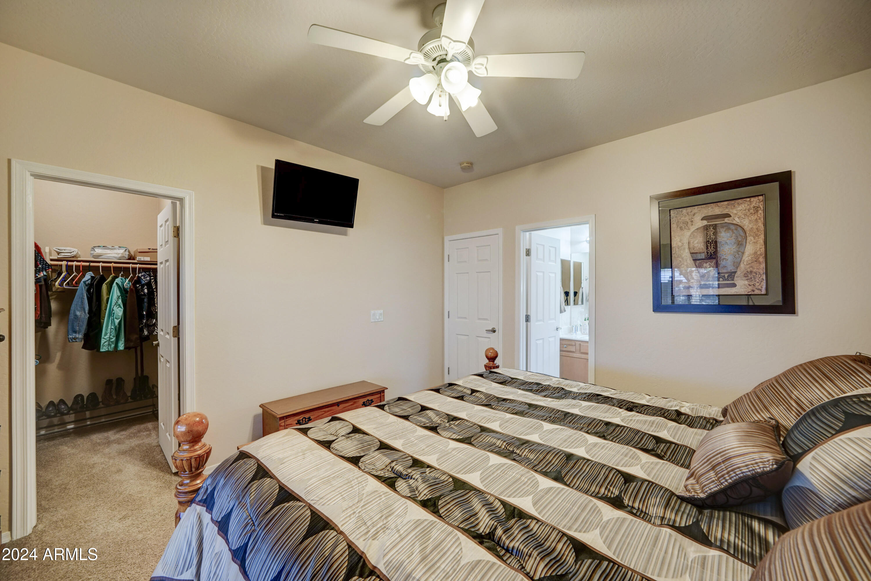 2101 South Meridian Road, Unit 131 Apache Junction, AZ 85120 - Photo 23 of 59 a bedroom with a bed and a flat screen tv