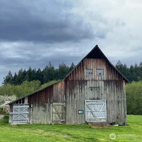 a backyard of a house with lots of green space and trampoline