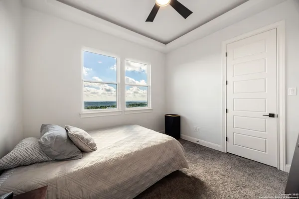 a bathroom with a granite countertop sink a toilet and shower