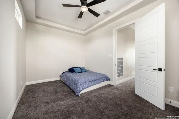 a bedroom with a bed and a potted plant