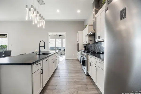 a kitchen with granite countertop white cabinets and white appliances