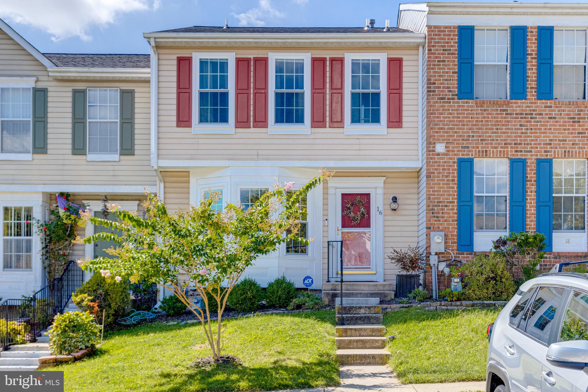 a front view of a house with a yard and fountain