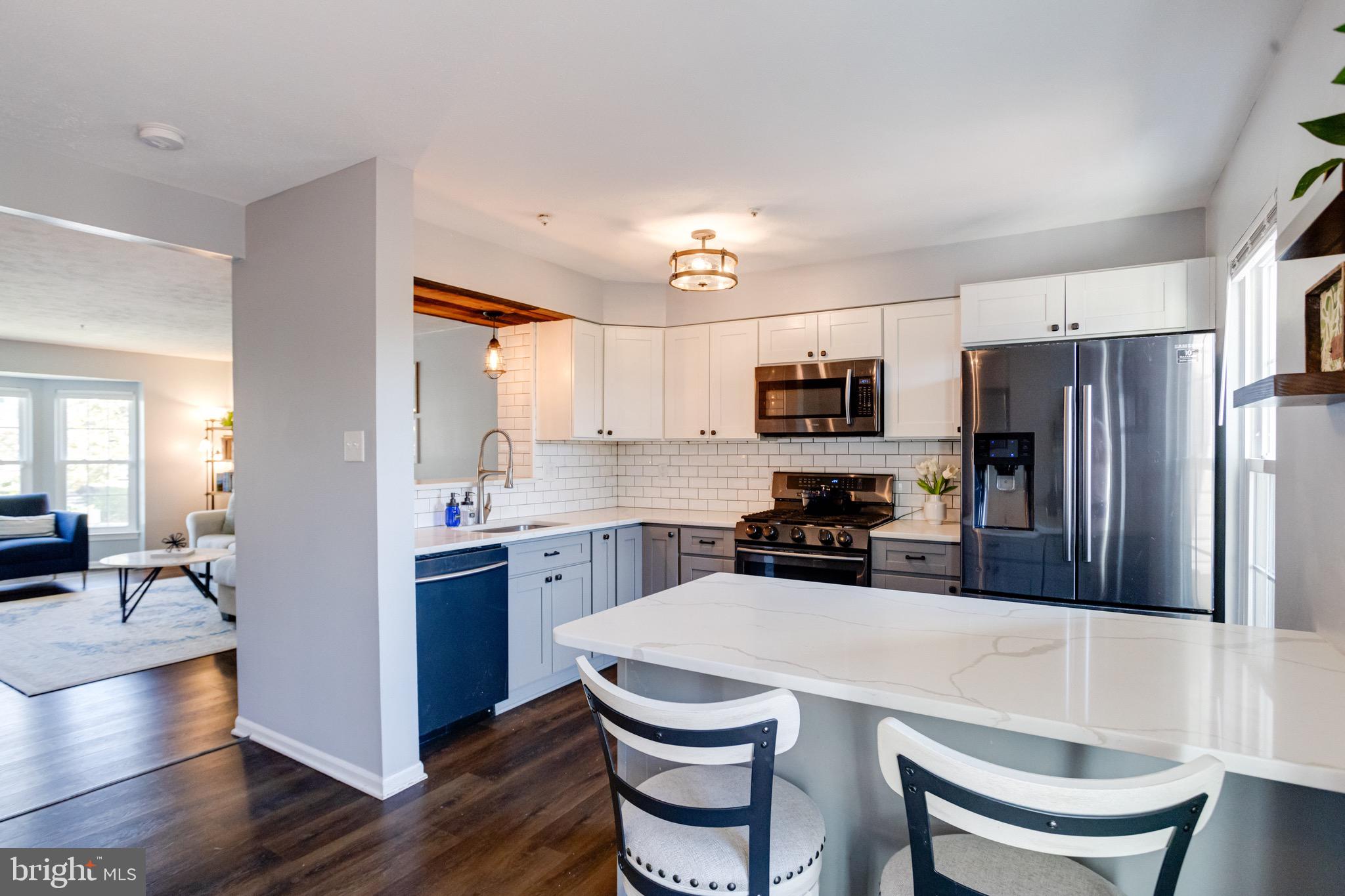 16 Sandview Court Baltimore, MD 21209 - Photo 11 of 58 a kitchen with refrigerator a stove and chairs