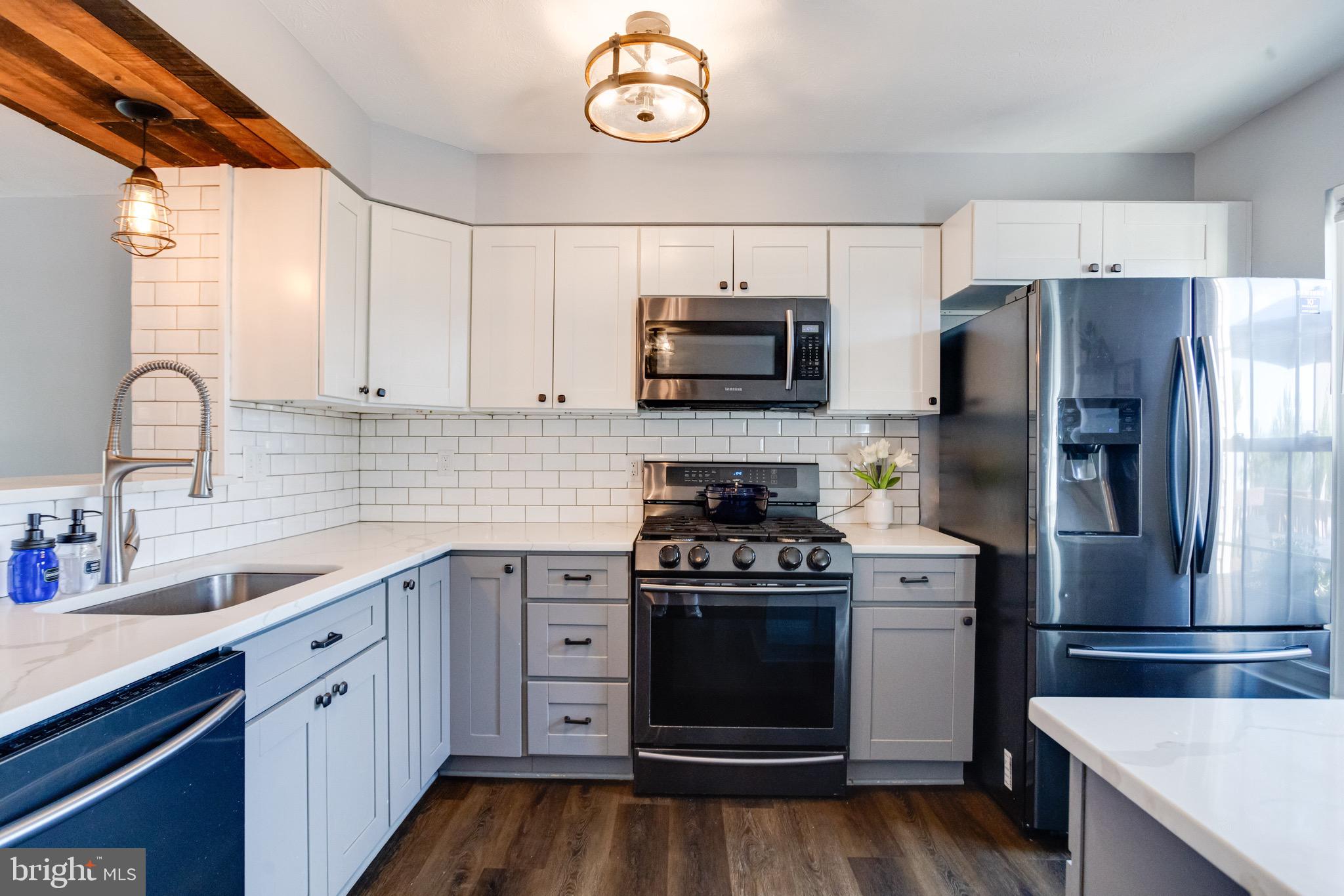 16 Sandview Court Baltimore, MD 21209 - Photo 12 of 58 a kitchen with cabinets stainless steel appliances a sink and a stove