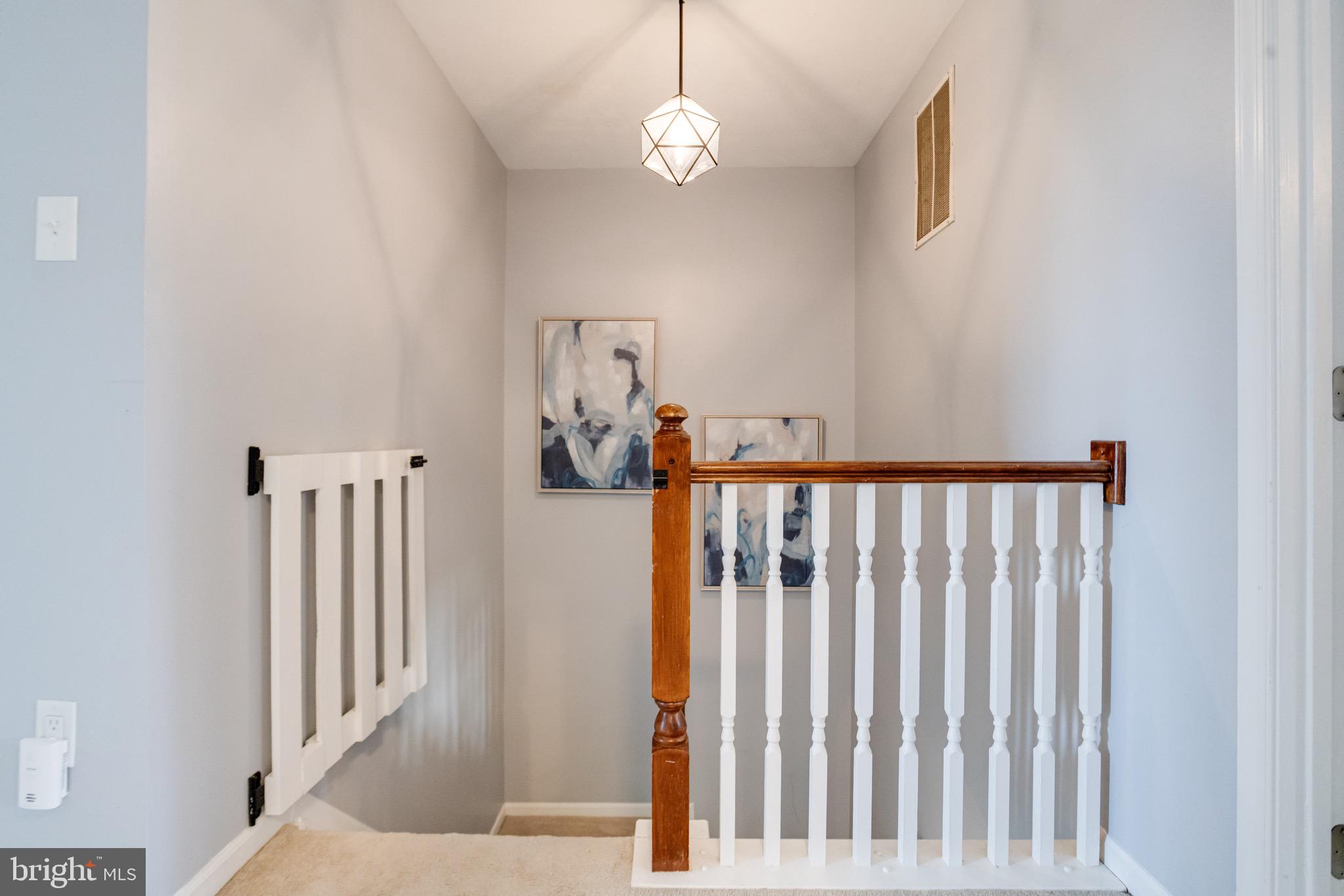 16 Sandview Court Baltimore, MD 21209 - Photo 21 of 58 a view of staircase with railing and a chandelier