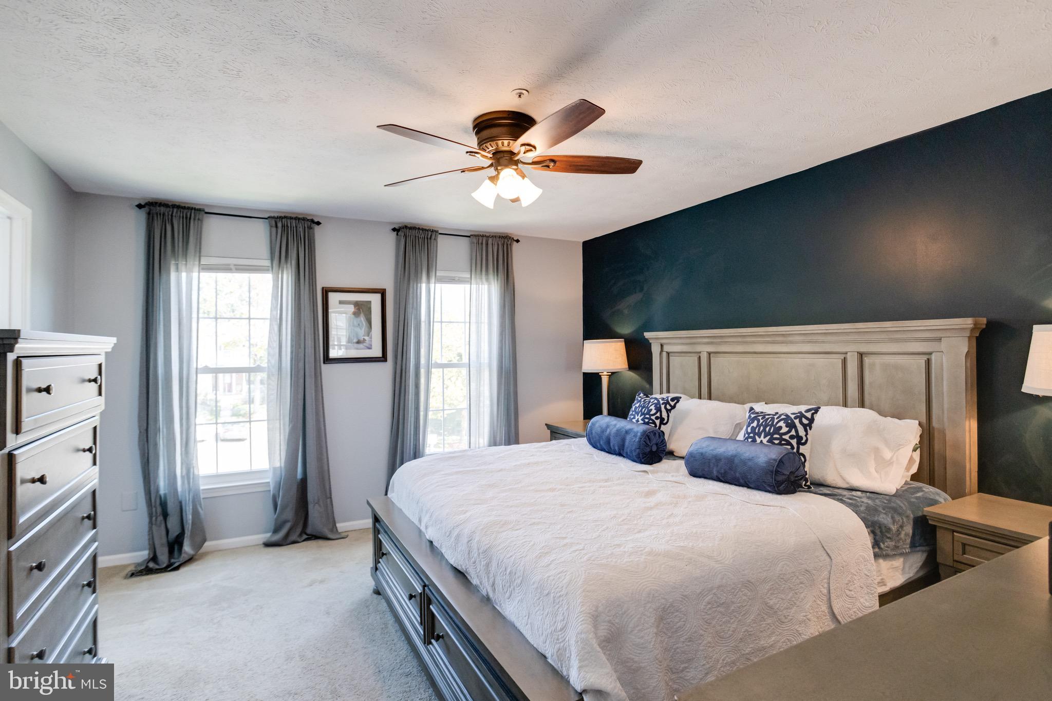 16 Sandview Court Baltimore, MD 21209 - Photo 22 of 58 a bedroom with a large bed and a chandelier