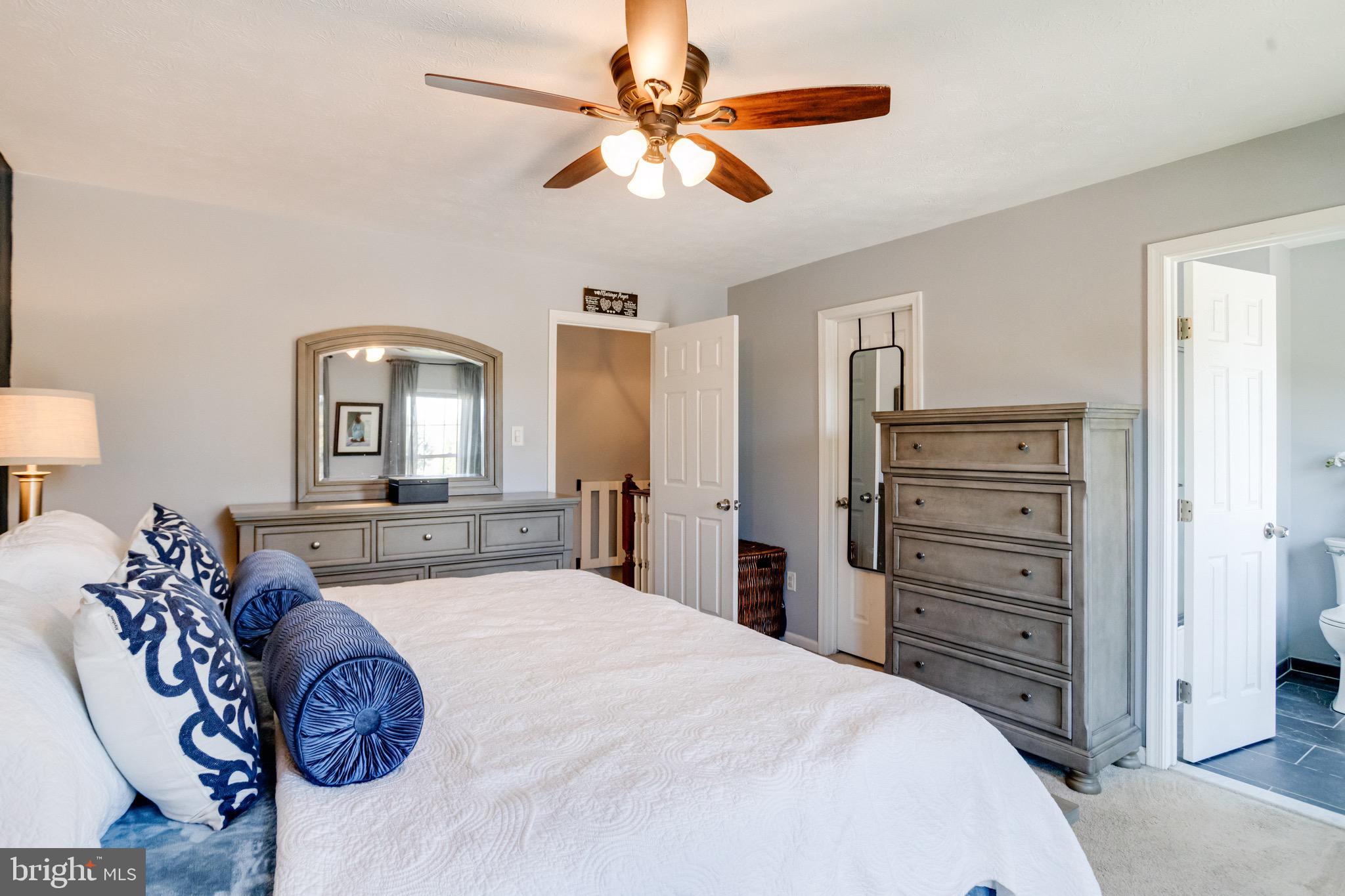 16 Sandview Court Baltimore, MD 21209 - Photo 27 of 58 a bedroom with a bed and dresser with mirror