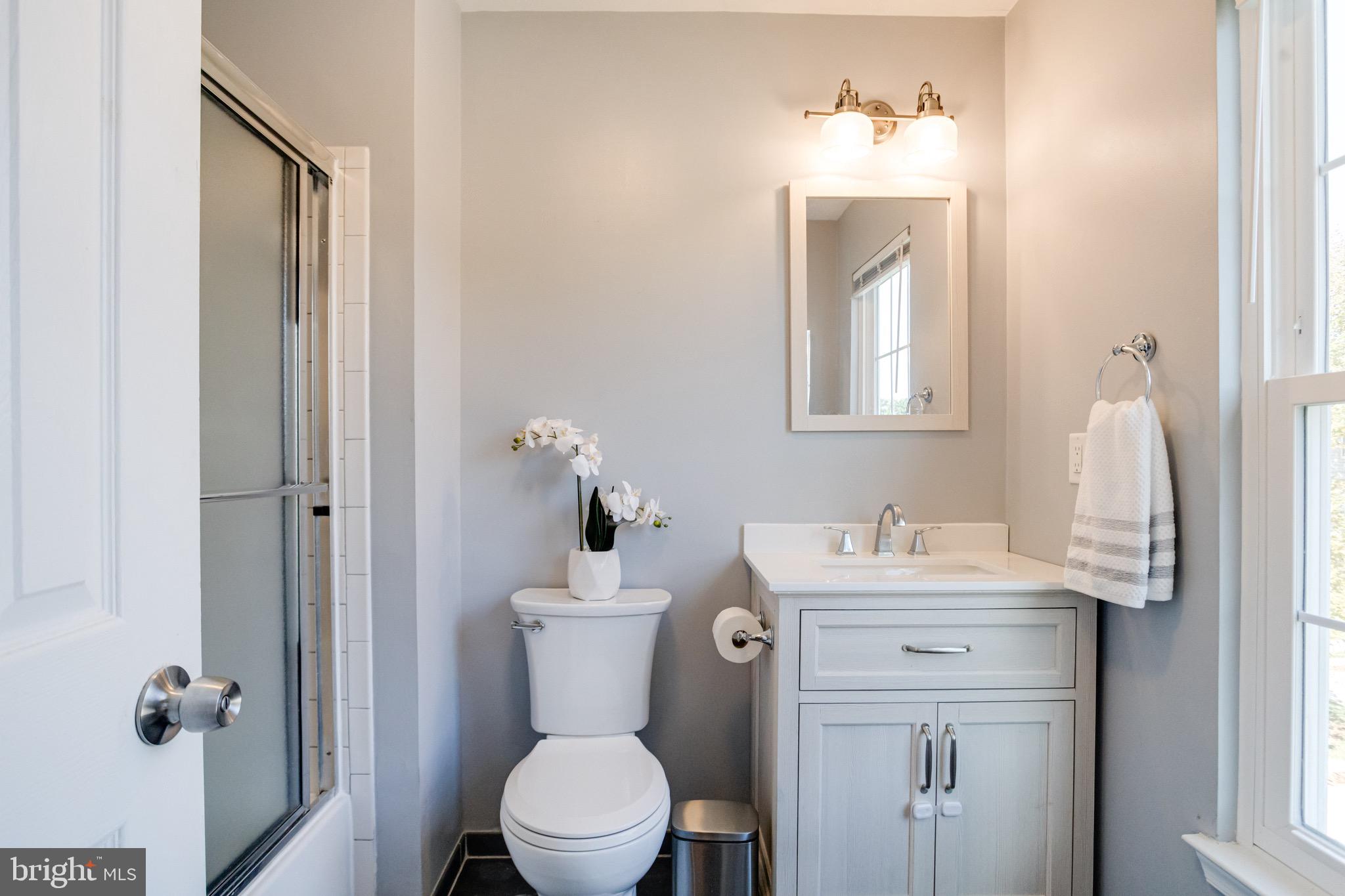 16 Sandview Court Baltimore, MD 21209 - Photo 28 of 58 a bathroom with a toilet sink and mirror