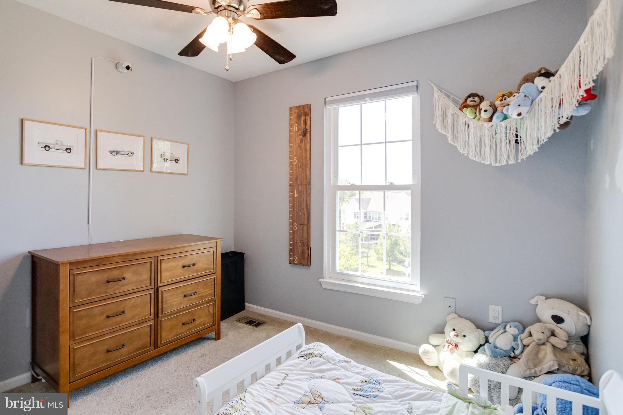 16 Sandview Court Baltimore, MD 21209 - Photo 32 of 58 a bedroom with a bed and a chandelier