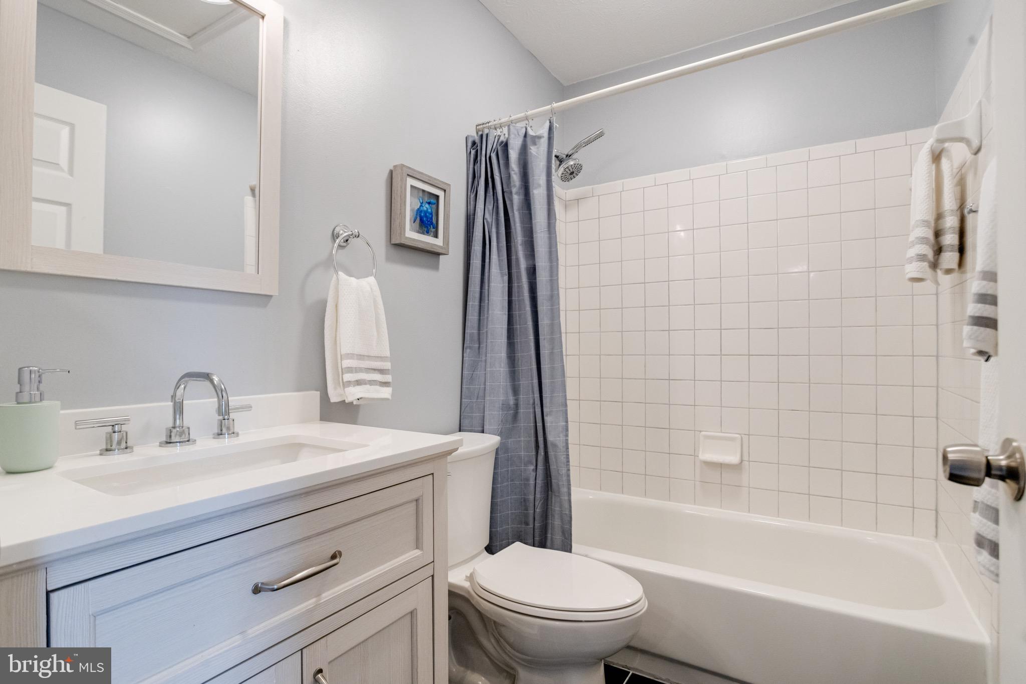 16 Sandview Court Baltimore, MD 21209 - Photo 36 of 58 a bathroom with a sink a toilet and shower