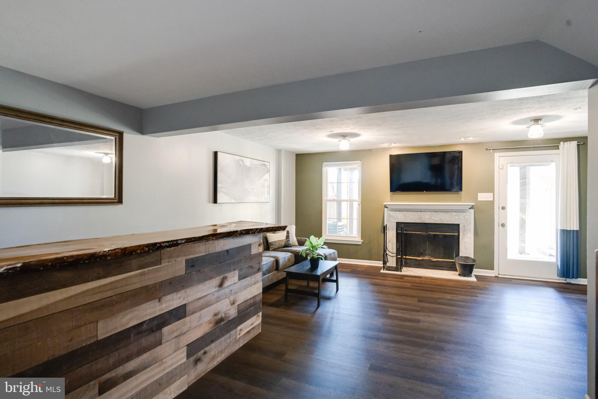16 Sandview Court Baltimore, MD 21209 - Photo 40 of 58 a living room with fireplace furniture and a wooden floor