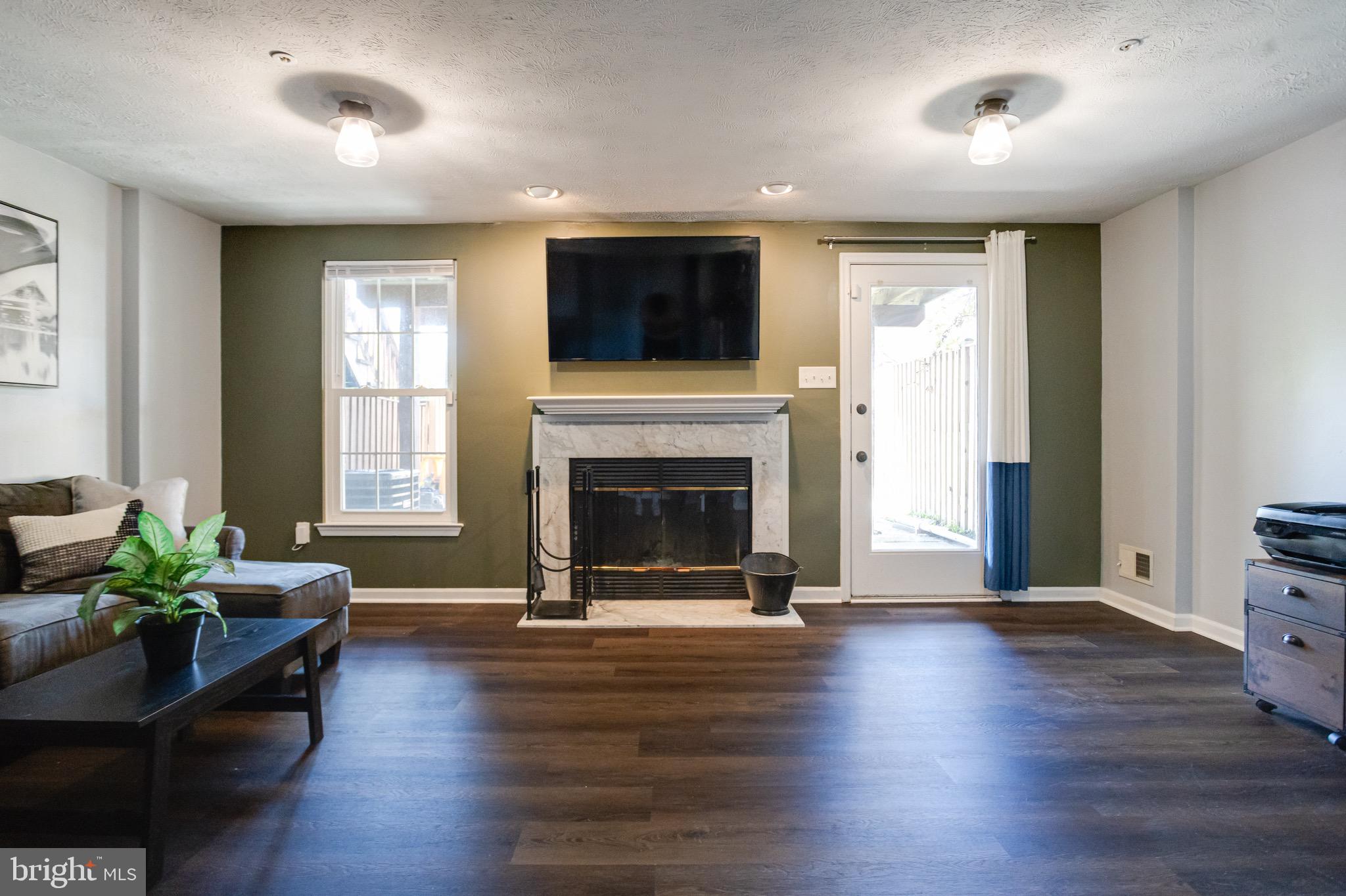 16 Sandview Court Baltimore, MD 21209 - Photo 41 of 58 a living room with furniture flat screen tv and a fireplace