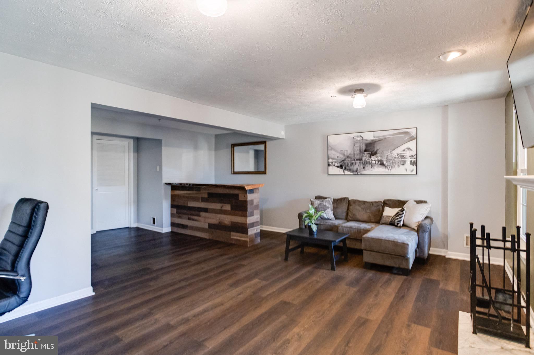 16 Sandview Court Baltimore, MD 21209 - Photo 45 of 58 a living room with furniture and a wooden floor