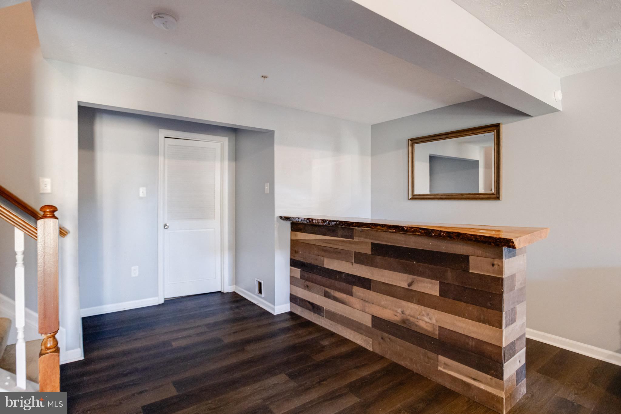 16 Sandview Court Baltimore, MD 21209 - Photo 47 of 58 a view of an empty room with wooden floor and a window