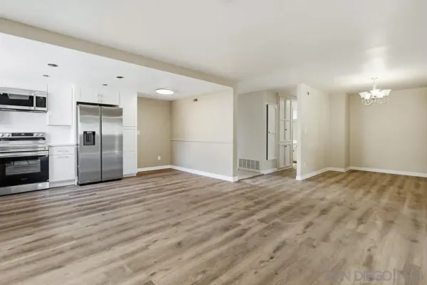 a view of a kitchen with a stove cabinets and wooden floor