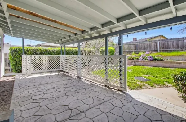 a view of swimming pool with lawn chairs and plants