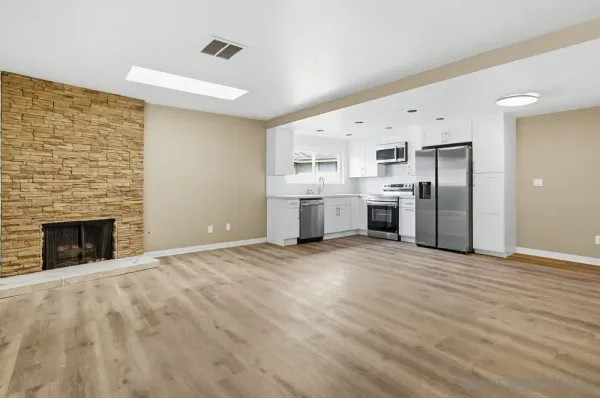 a view of a kitchen with a sink cabinets and a fireplace