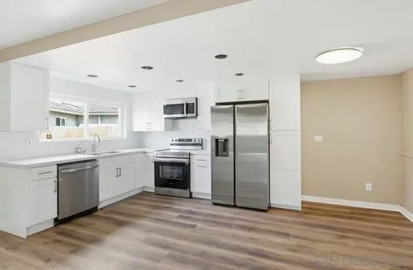 a kitchen with a sink stainless steel appliances and cabinets