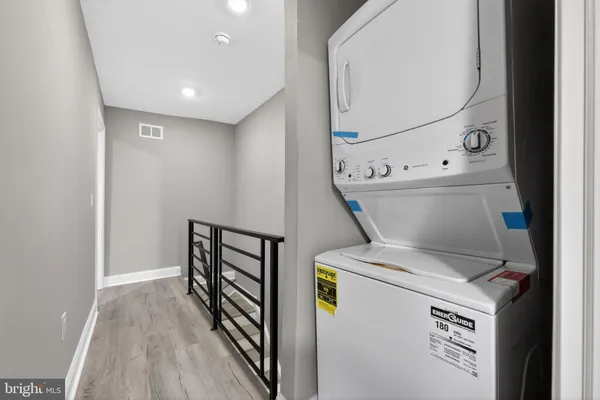 a view of washer and dryer with wooden floor