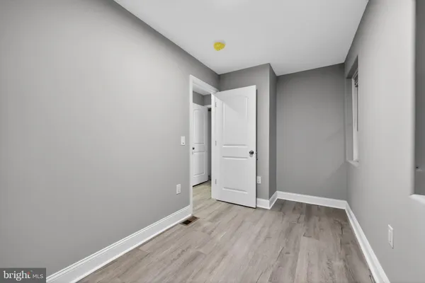 an empty room with wooden floor
