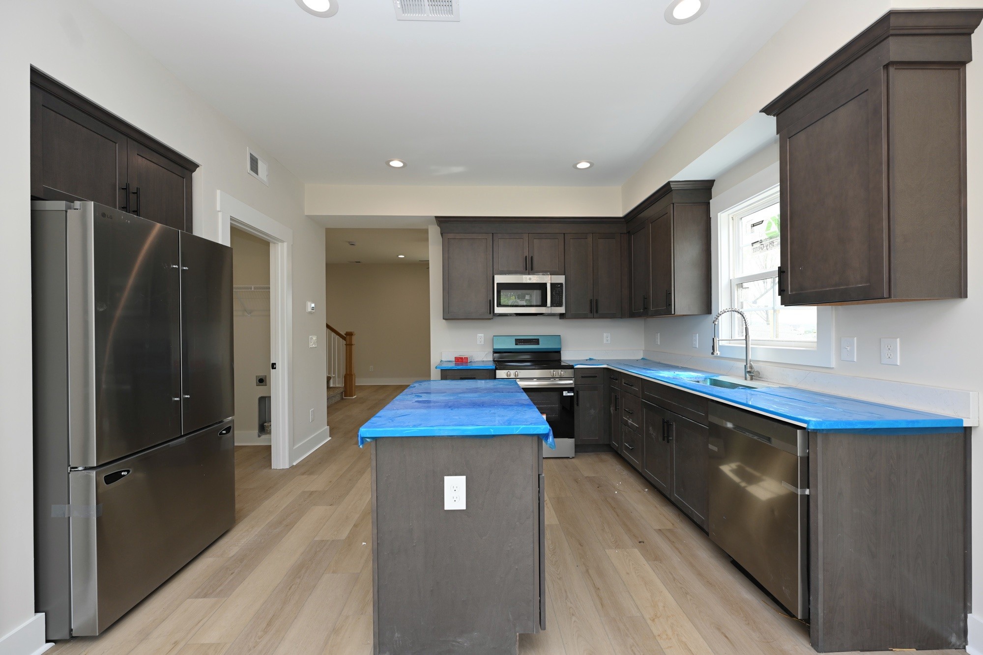 1204 Sylvia Drive Madison, TN 37115 - Photo 22 of 44 a kitchen with stainless steel appliances granite countertop a refrigerator a sink a stove a microwave and wooden cabinets