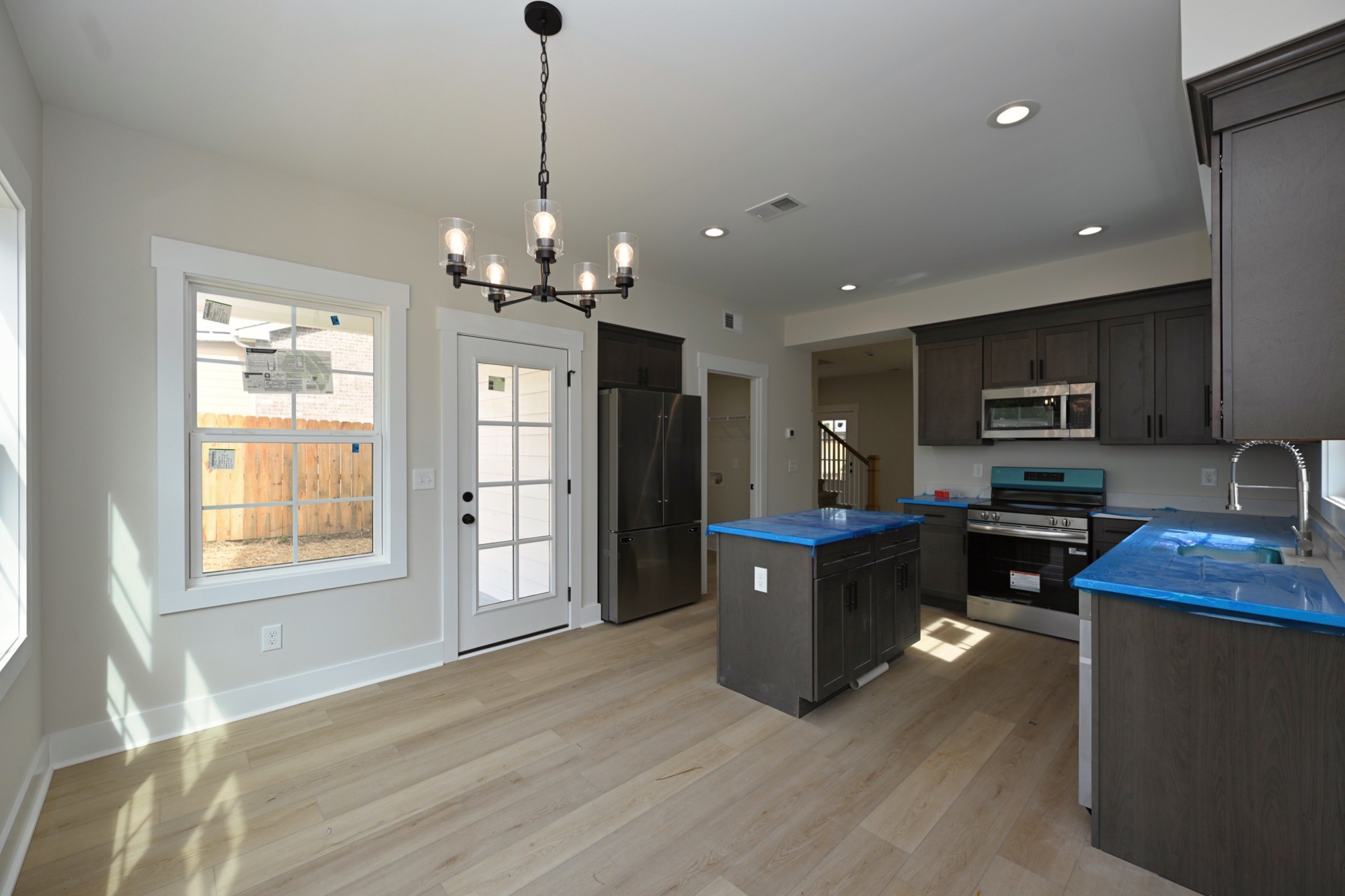 1204 Sylvia Drive Madison, TN 37115 - Photo 25 of 44 a kitchen with stainless steel appliances granite countertop a refrigerator a sink dishwasher a oven and a dining table with wooden floor