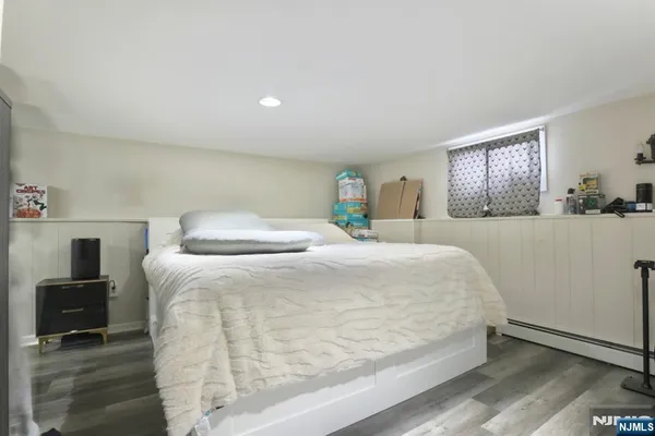 a bedroom with a bed and a tv