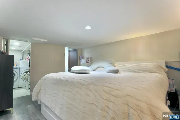 a large white bed in a white room