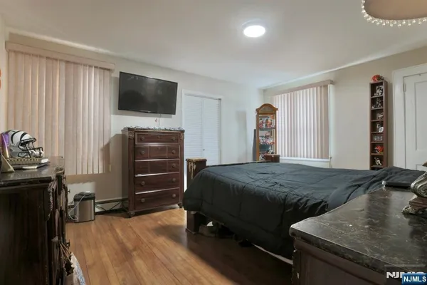 a bedroom with a bed and a television