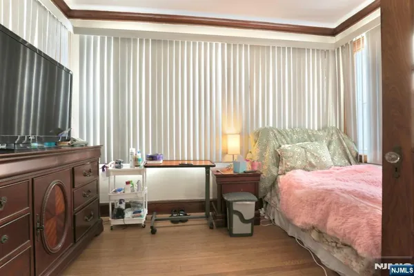 a bedroom with a bed and large windows