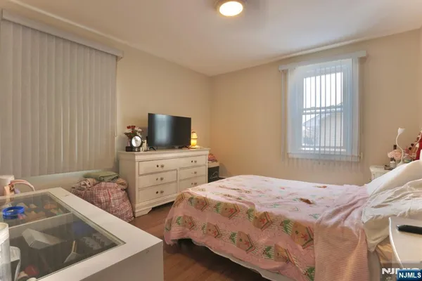 a bedroom with a bed and flat screen tv