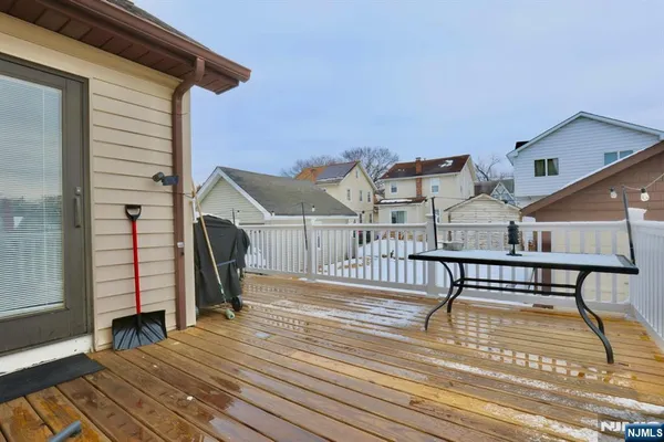 a view of a terrace with wooden floor and a barbeque