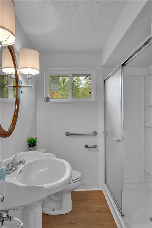 9830 Don Drive Irwin, PA 15642 - Photo 16 of 30 a bathroom with a sink a toilet and shower