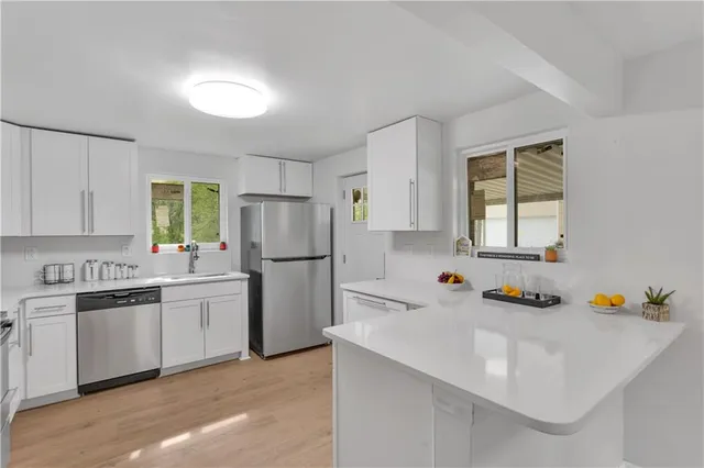 a kitchen with a sink a stove and refrigerator