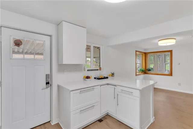 a view of a kitchen with dining table and chairs