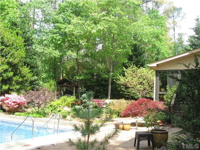 8609 Harbor Drive Raleigh, NC 27615 - Photo 4 of 25 Gorgeous landscape.....careful thought to the design of gardens and pool so that it provides relaxation and a truly "welcome home" each day.