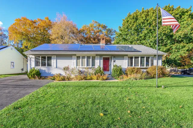 a front view of a house with a garden