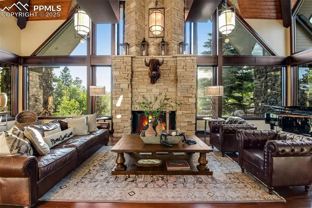 a living room with furniture fireplace and a large window