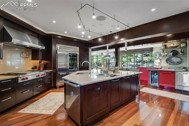 a kitchen with stainless steel appliances granite countertop sink stove top oven and cabinets