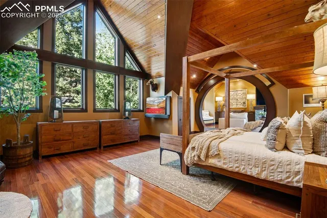 a bedroom with a large bed and a large window