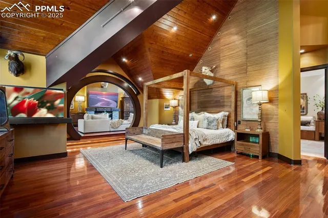 a bedroom with furniture and wooden floor