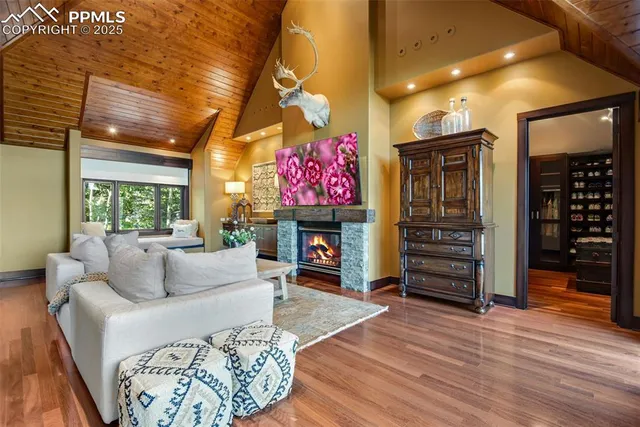 a living room with fireplace furniture and a wooden floor