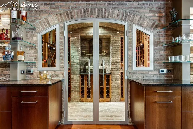 a living room with furniture kitchen view and a large screen