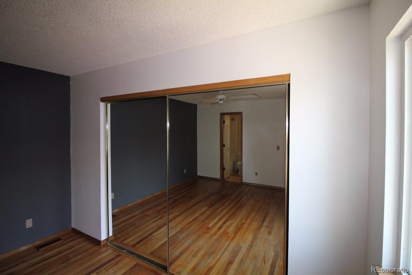 587 Longfellow Lane Highlands Ranch, CO 80126 - Photo 6 of 13 a view of a hallway with wooden floor