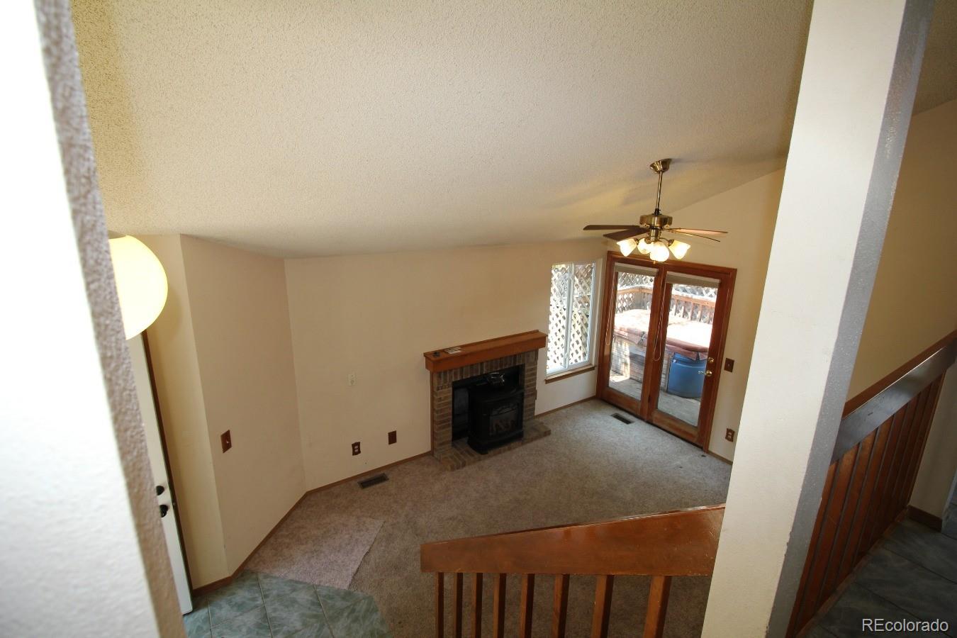 587 Longfellow Lane Highlands Ranch, CO 80126 - Photo 8 of 13 a view of a livingroom with an empty space and a fireplace